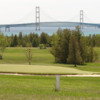 A view of a hole protected by a bunker at St. Ignace Golf & Country Club