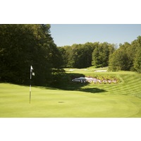 The ninth hole on the Threetops golf course at Treetops Resort plays over a valley to a green at 140 yards.